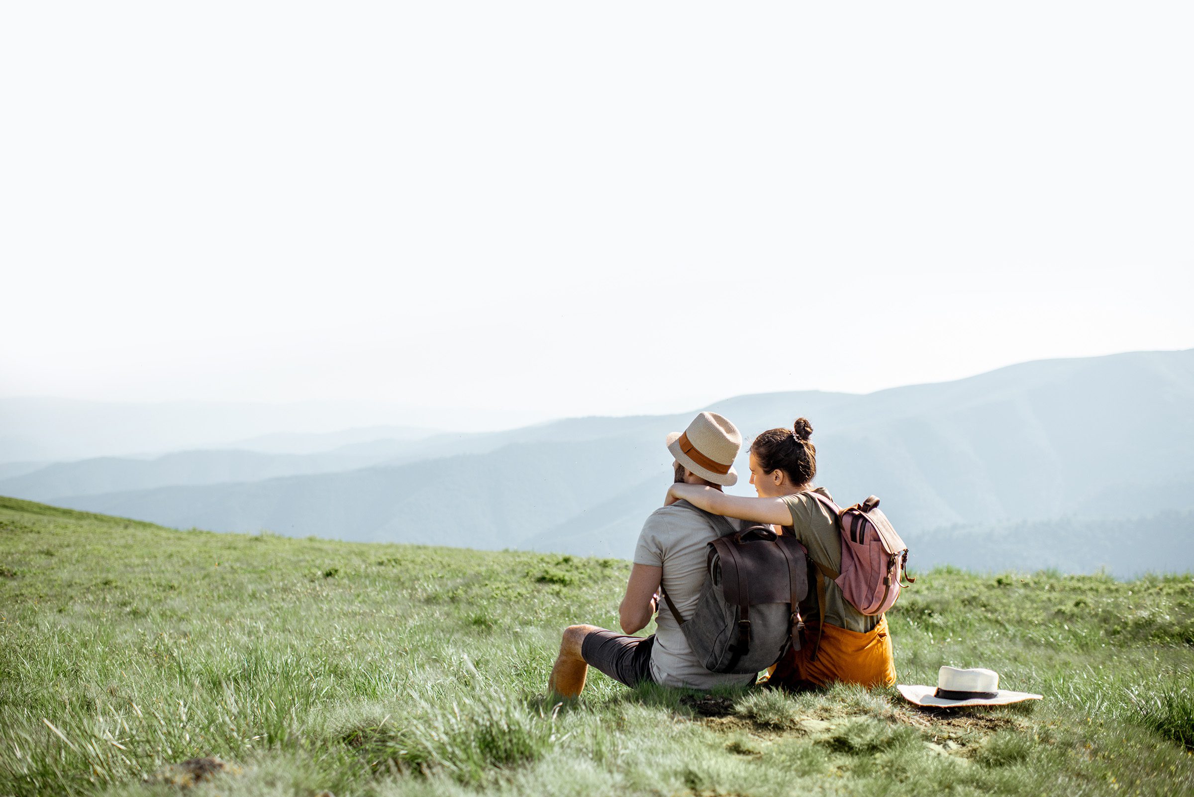 A couple walking a trail together outdoors